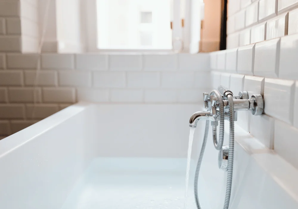 A bathtub faucet filling up the tub with water