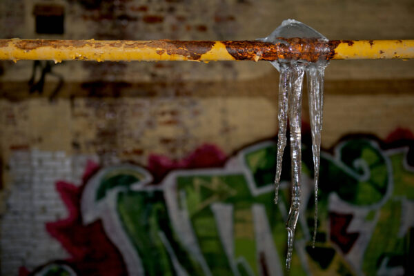 Frozen pipe with icicles